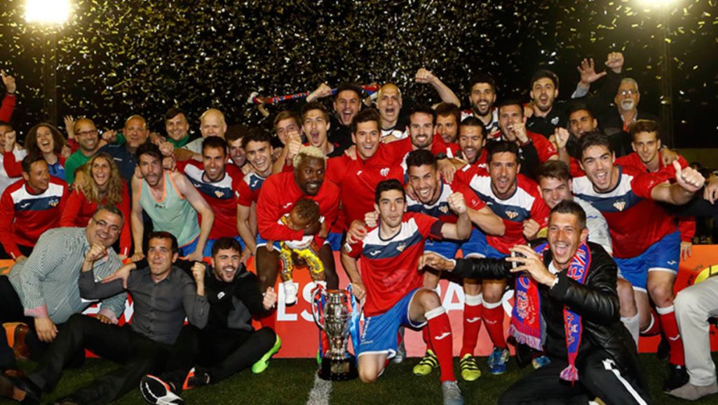 Imagen: Plantilla del Atlético Saguntino celebrando la Copa RFEF 2017 lograda ante su afición en Sagunto. Fuente: FFCV.